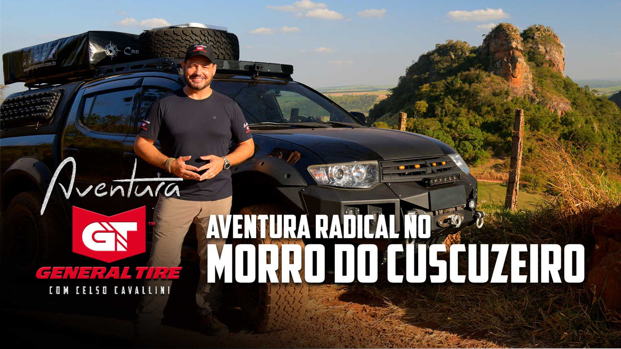 Imagem mostra um homem em pé ao lado de uma caminhonete preta equipada para off-road, com pneus robustos e acessórios. Atrás, o Morro do Cuscuzeiro se destaca na paisagem natural. O homem, sorrindo, veste uma camisa preta e um boné. O texto sobreposto diz: "Aventura General Tire com Celso Cavallini - Aventura Radical no Morro do Cuscuzeiro". O logotipo da General Tire também está presente na imagem.